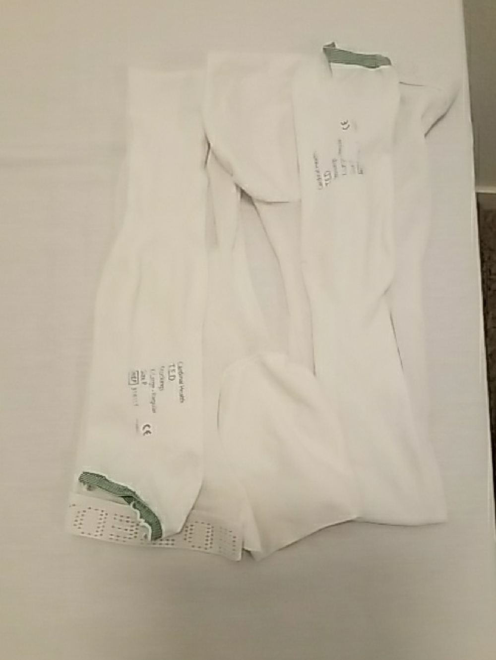 White Compression Garment with Green Trim Accents